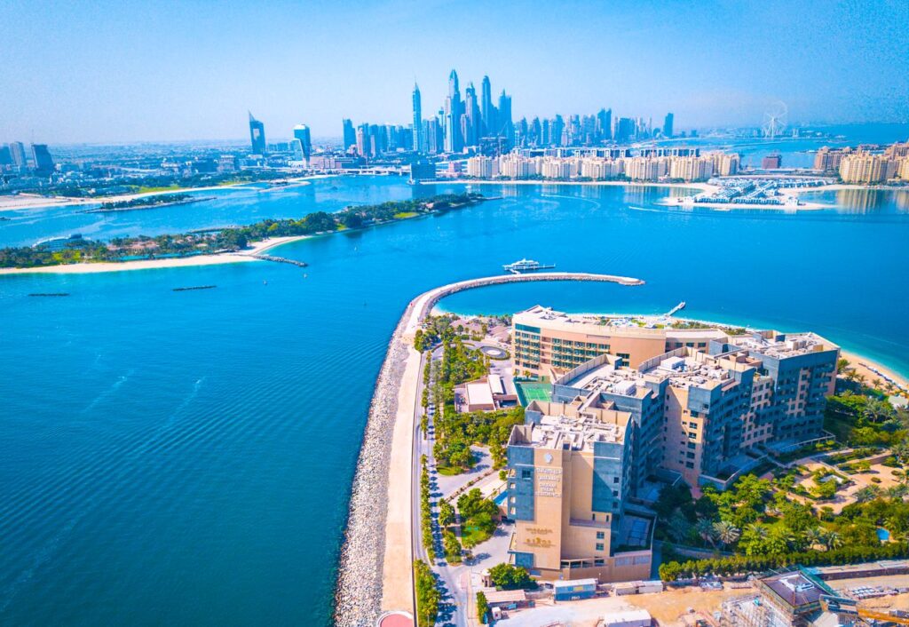 Experience the vibrant Dubai skyline with a breathtaking waterfront aerial view, showcasing modern architecture and urban beauty.