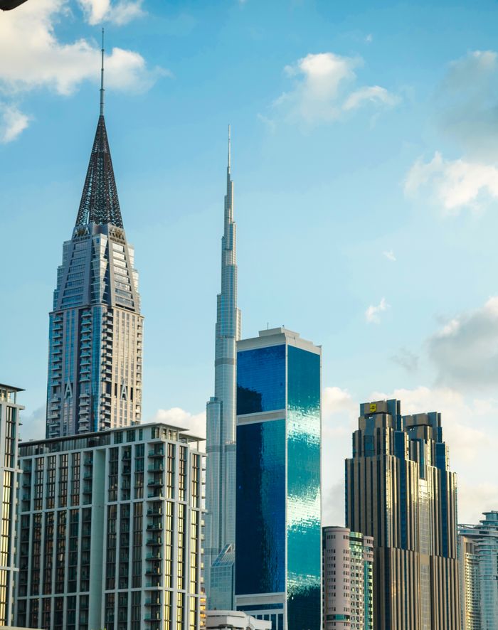 Vibrant Dubai skyline showcasing the towering Burj Khalifa against a bright sky.